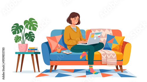 Young woman working on laptop on sofa at home.