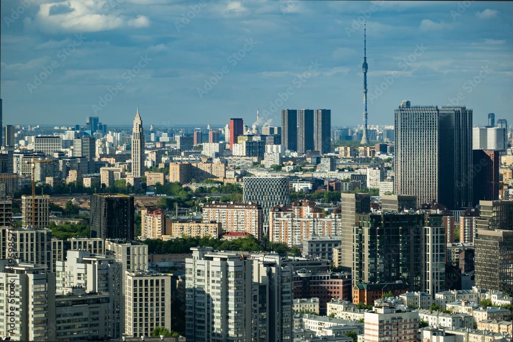 Fototapeta premium Moscow city skyline with Ostankino Tower dominating the urban landscape under sky