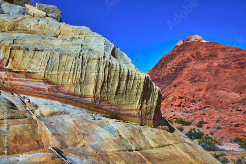 Layered Sandstone Texture and Red Rock Mountain Under Blue Sky