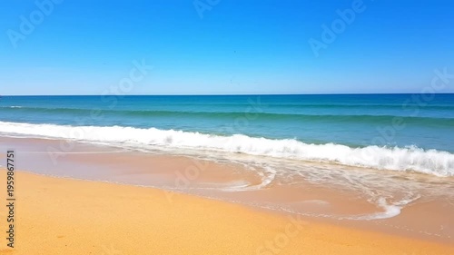 Serene ocean waves on sandy beach.