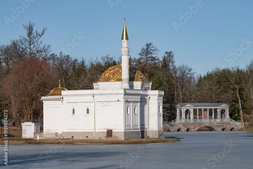 View of the Turkish Bath pavilion and Marble bridge on Big pond on a sunny March day. Catherine park of Tsarskoye Selo. St. Petersburg, Russia