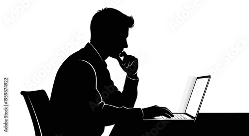 Silhouette of a thoughtful businessman working on a laptop at a desk