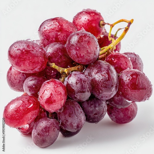 A close-up studio shot showcases a cluster of plump, glistening red grapes. The fruit is wet with droplets, and a thin, brown stem supports them