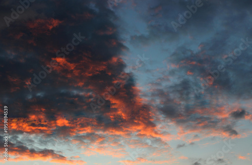 Foto Red and purple rain clouds backlit by the setting sun
