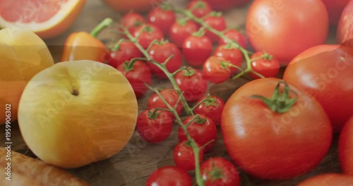 Vertical video: Gliding camera revealing cluster of cherry tomatoes on tabletop for food styling