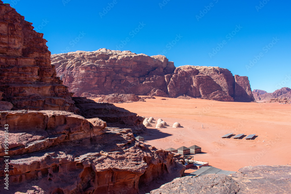 Fototapeta premium Wadi Rum known also as the Valley of the Moon or Red mountains. Valley cut into the sandstone and granite rock in southern Jordan, near the border with Saudi Arabia.