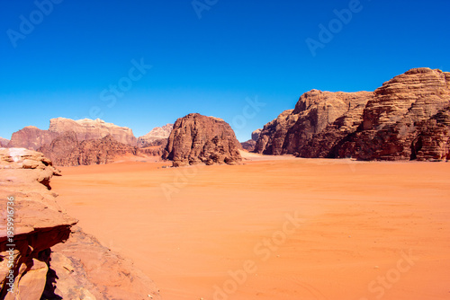 Wadi Rum known also as the Valley of the Moon or Red mountains. Valley cut into the sandstone and granite rock in southern Jordan, near the border with Saudi Arabia.