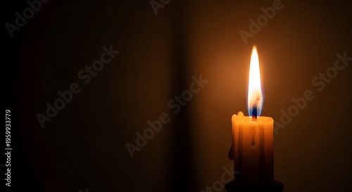 Luminous candle flame on a dark, empty background. Ideal for bereavement concepts, spiritual meditation, and honor of the deceased with plenty of text space
