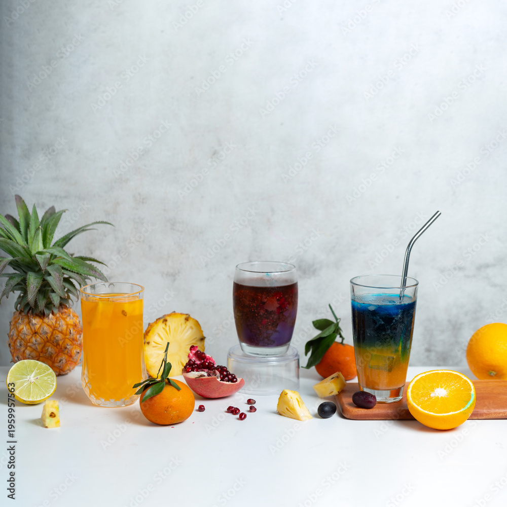 Fototapeta premium Fresh fruit drinks with citrus and berries on white background