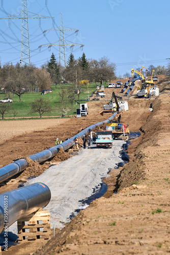 Large pipeline construction site in Ludwigsburg district, Baden-Württemberg, Germany. Workers and machinery install underground pipes for future gas and hydrogen energy supply across agricultural land
