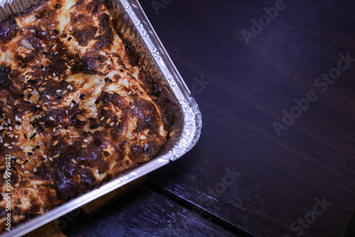Traditional baked pie in a functional foil tray suitable for catering and food delivery services. Concept for small business bakery, food packaging and easy home meal