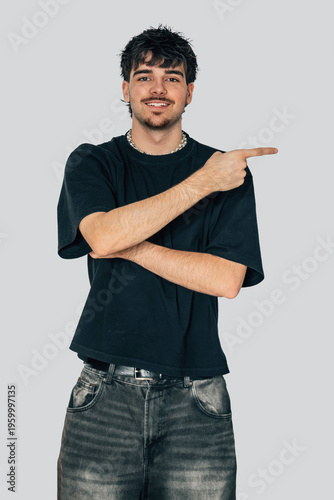 fashionable young man isolated on background pointing, vertical half-body portrait