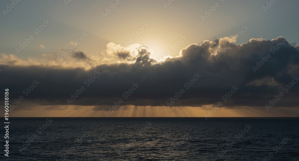 Fototapeta premium Heavy clouds obscuring sun over ocean