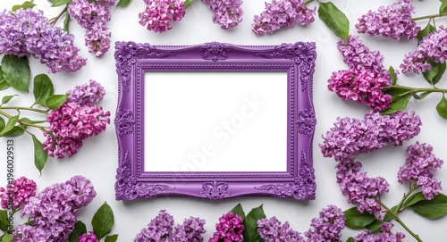 Floral art display featuring violet lilac blossoms surrounding a decorative purple frame on a white backdrop