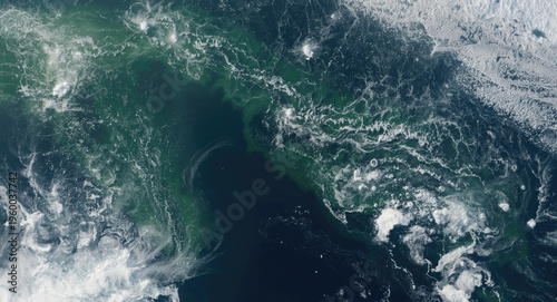 Orbital image revealing tsunami wave patterns and swirling sea waters moving toward built-up coastal zones