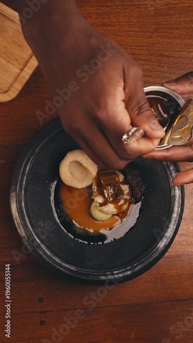dishes of haute cuisine presentation serving details in dishes. chef hands put greens flowers sauce on plate. close up white plate in restaurant. food in Michelin restaurant. modern cooking technology