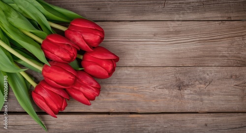 Proud red tulips vividly displayed on a rustic wooden surface
