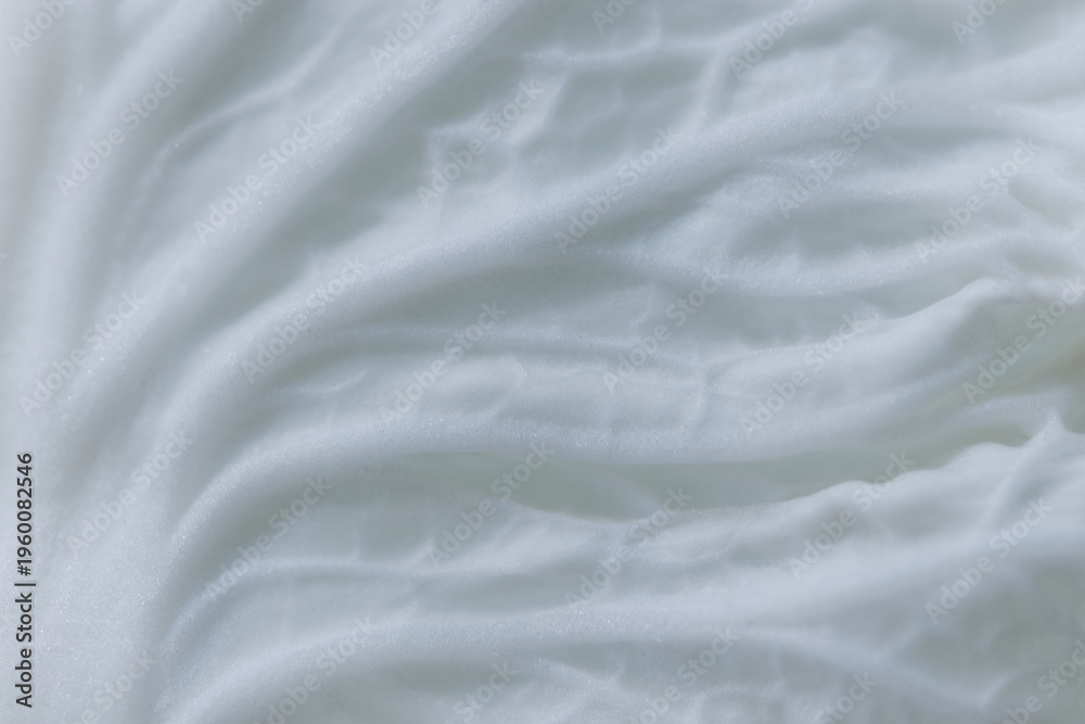 Fototapeta premium Macro close-up cabbage leaf structure with soft flowing layers and natural white texture