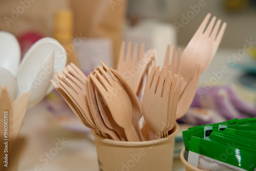 Wooden sporks in cup serving eco-friendly disposable cutlery