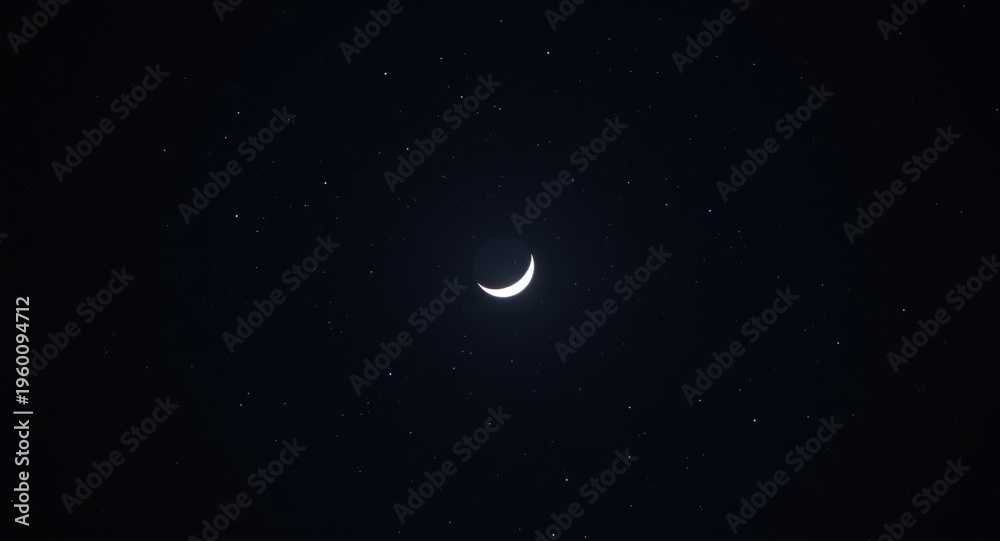 Fototapeta premium Moon eclipsing under a starry nighttime sky