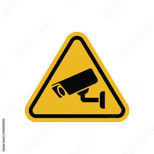 A yellow triangle warning sign indicates a surveillance camera is present.