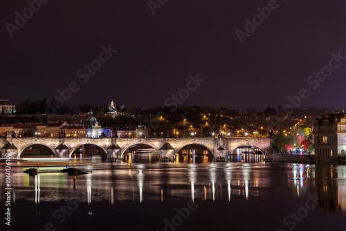 Billede på lærred Charles Bridge in Prague in the evening with colorful lights from lanterns