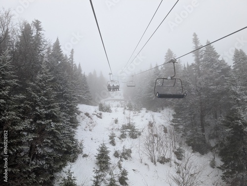Skiing in winter - chairlift and ski slopes for skiing and snowboarding  between trees on a frosty day with beautiful views in  mountains