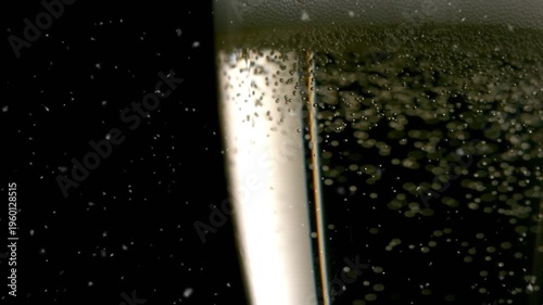 Animation of snow falling over glass of champagne