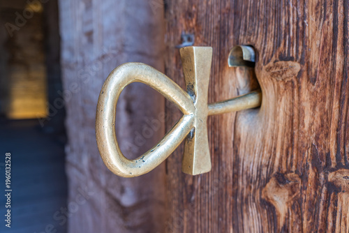 фотографія Ankh key, symbolizing life and eternity, securing a wooden door within the grand