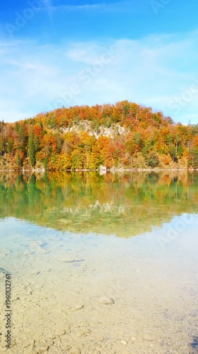 Alpine lake with autumn forest
