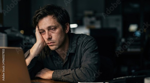 Exhausted Businessman Working Late at Night on Laptop