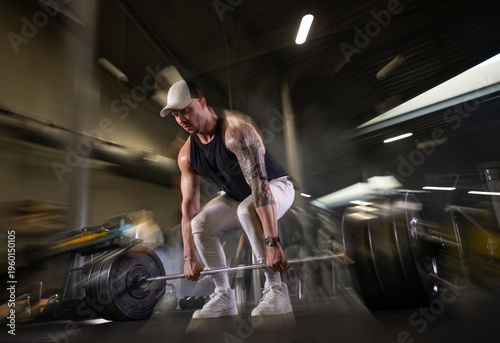 Fitness and health concept. A fit young man works out in a modern gym. Athletic man doing exercise.