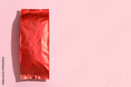 Red coffee bag on pink back...