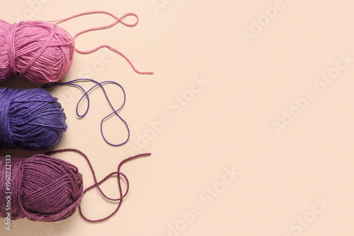 Colorful yarn on beige back...