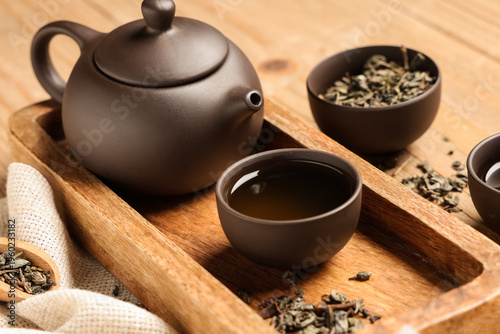 Teapot with cup of tea and ...