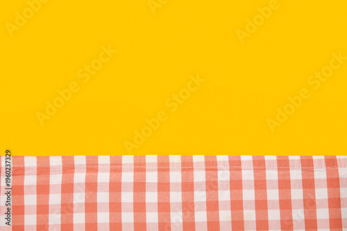 Red checkered napkin on yel...