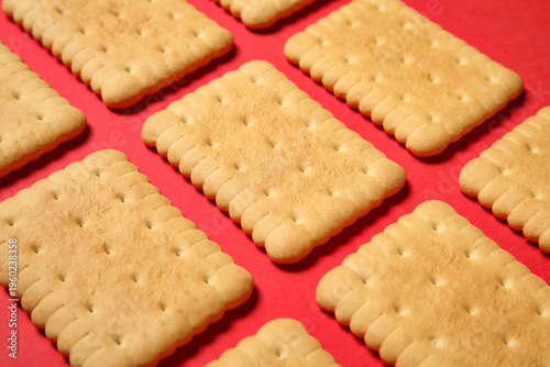 Tasty sweet cookies on red ...