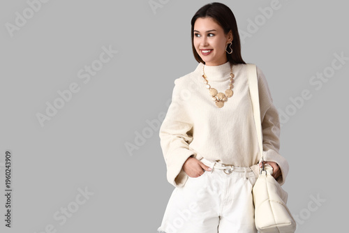 Stylish young woman in whit...