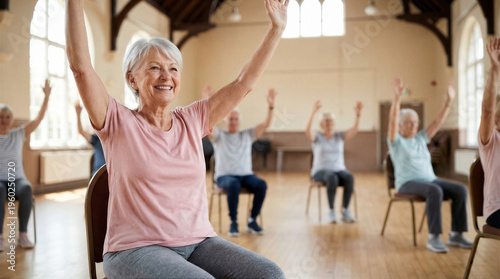 Group of active seniors participating in a chair exercise class in a community center, focusing on health and fitness in old age