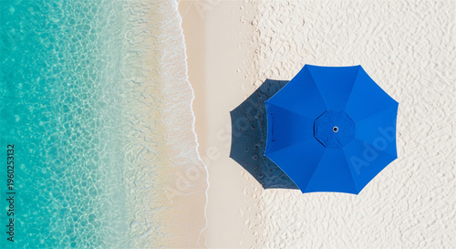 Minimalist aerial beach view with blue umbrella, turquoise ocean water on white sand, tropical summer vacation background with copy space