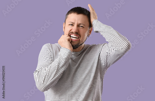Screaming young man on lila...