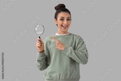 Young woman pointing at mag...