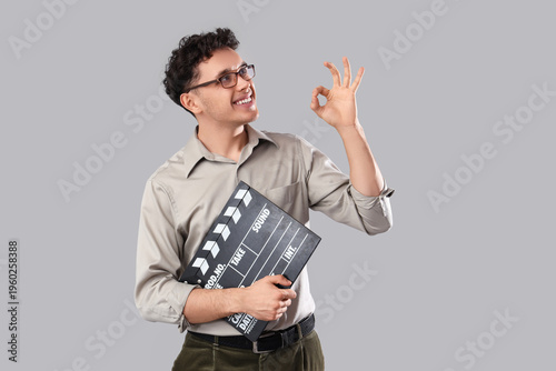 Young man with movie clappe...