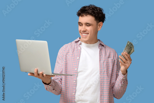 Happy young man with laptop...