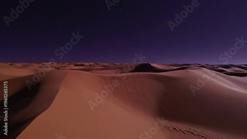 Vast rust-colored desert dunes under dramatic sunset skies with glowing ridges