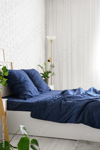 Bed with stylish blue beddi...