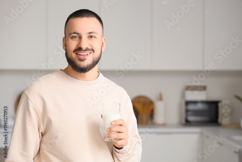 Handsome man with glass of ...