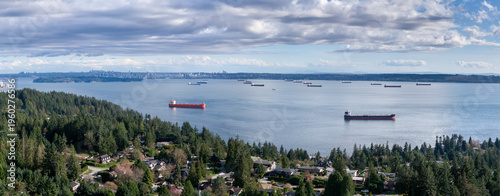 Cargo Ships Anchored in Burrard Inlet Off West Vancouver, BC, Canada With Coastal Forest Homes