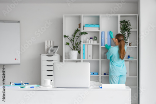 Young female doctor taking ...