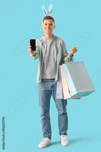 Young man in bunny ears wit...